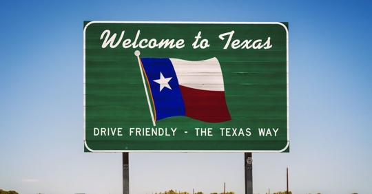 Photo of Texas' "Welcome to Texas" state sign. Inscription reads: Drive Friendly - The Texas Way.