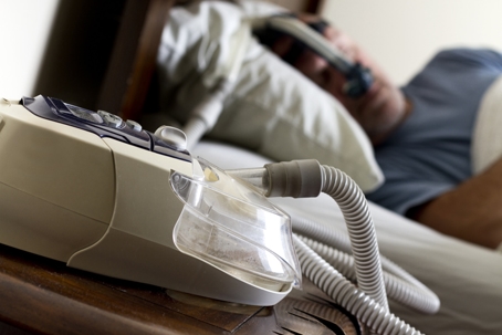 Man sleeping with CPAP machine